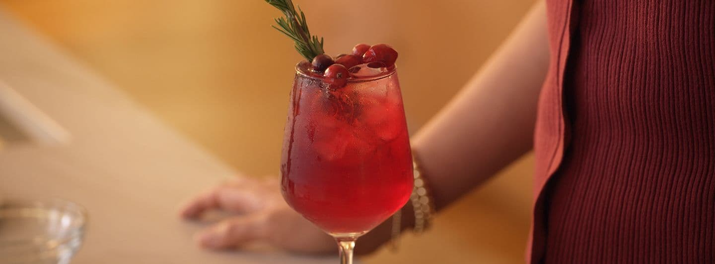 Tall glass of red-colored low-sugar alcoholic drink