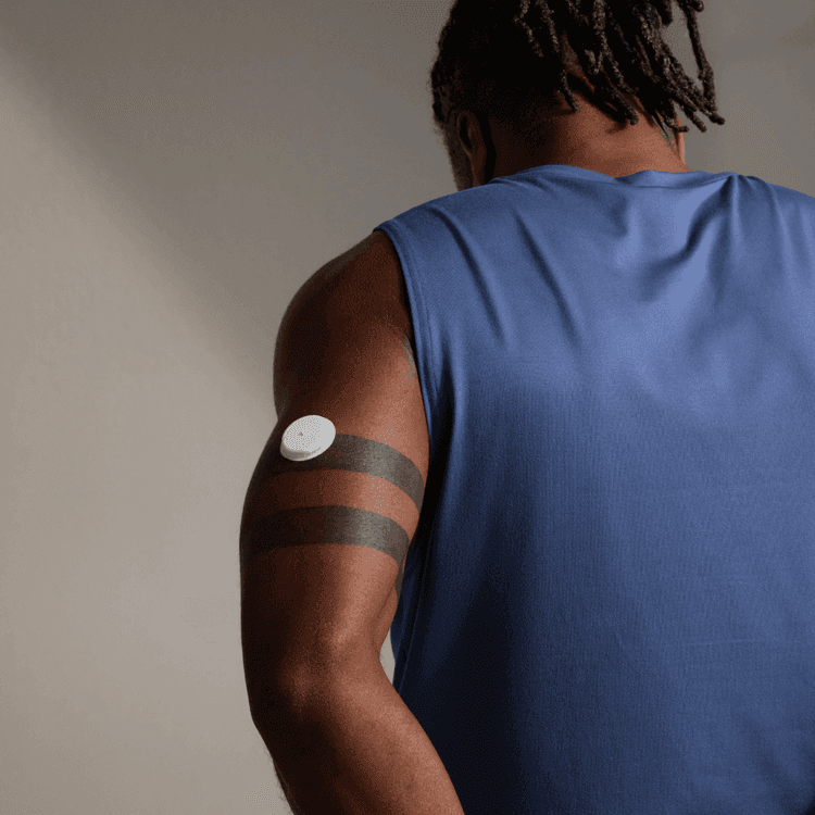 A man facing backwards, wearing a Lingo biosensor